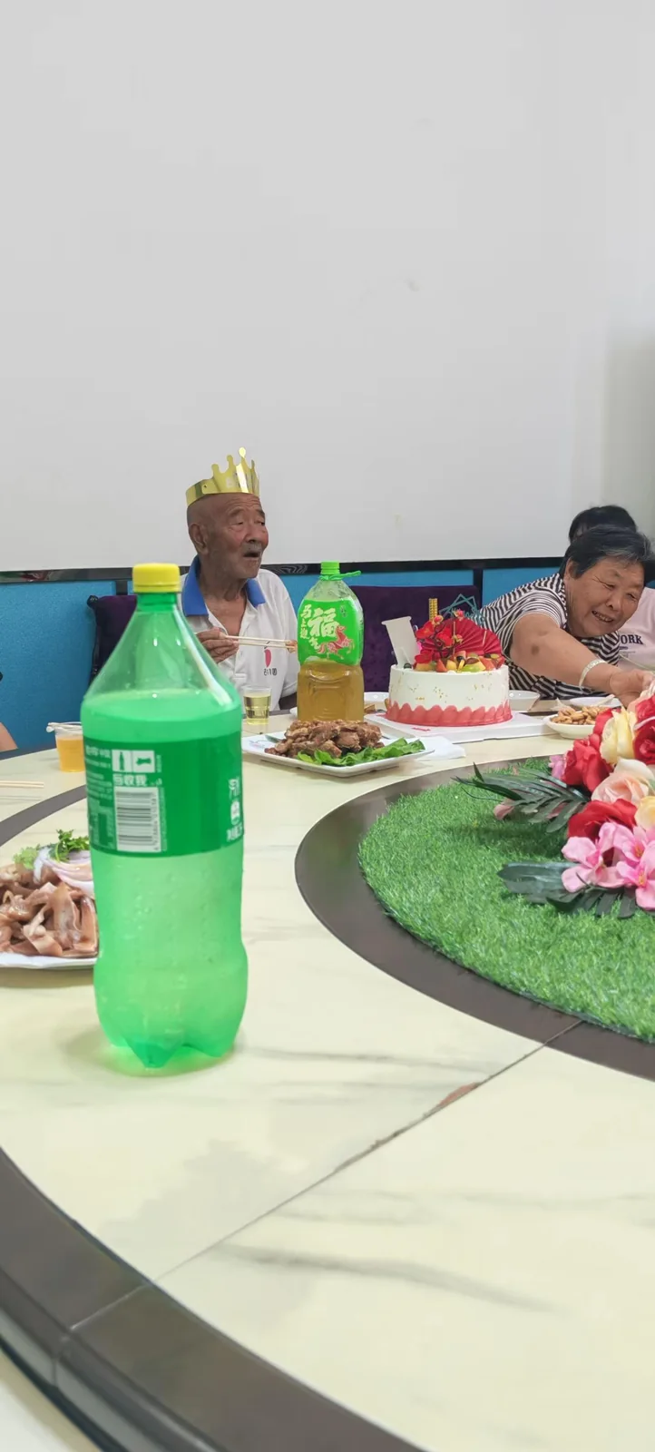 姥爷坐在蛋糕后方